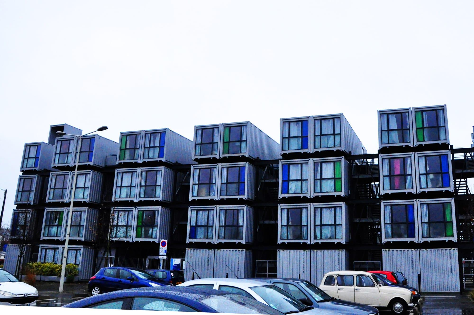 Four storeys of stacked shipping containers forming student apartments with large windows